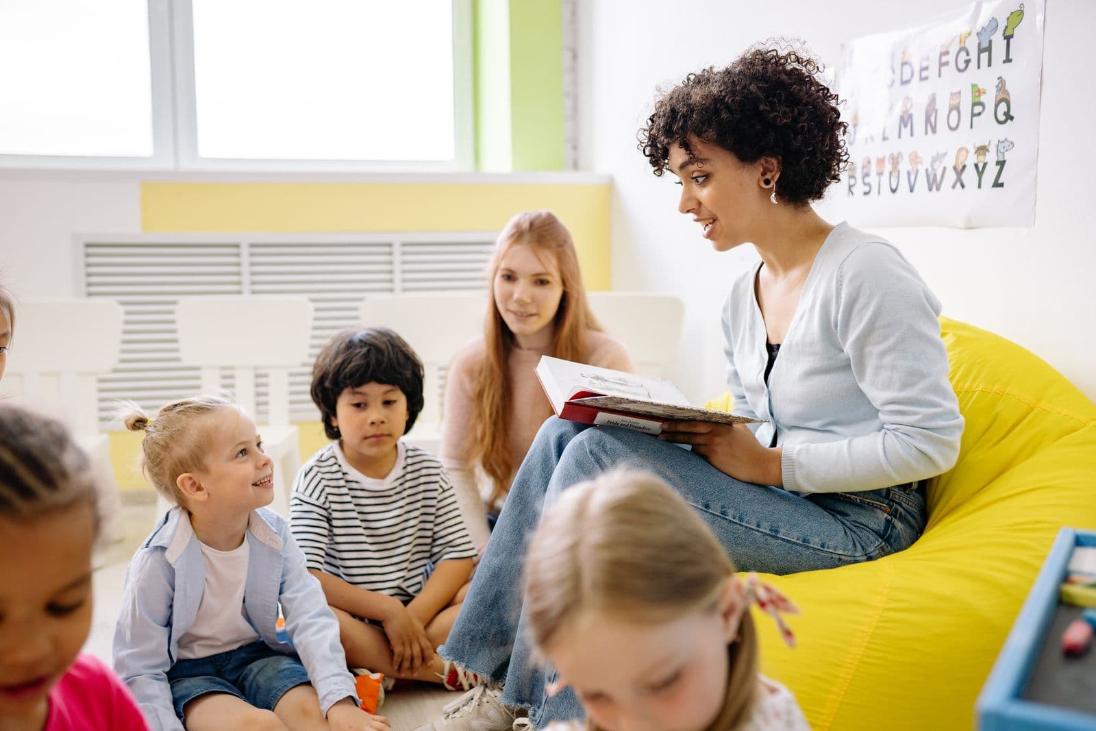 Young children gathered for circle time in a bright classroom